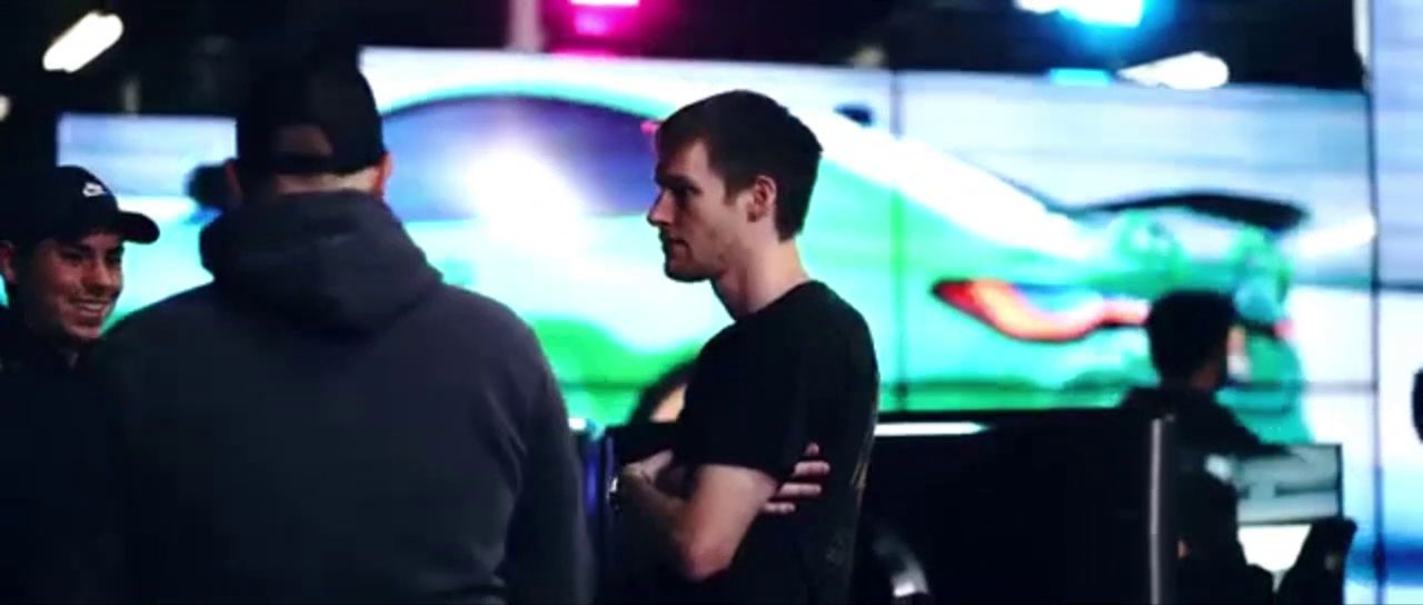 Friends talking in front of the racing simulators